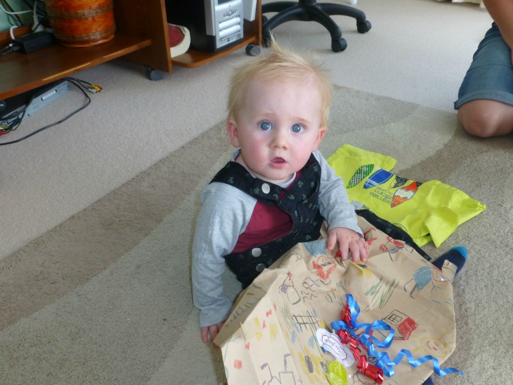 Young Jayden takes delight in gift opening.